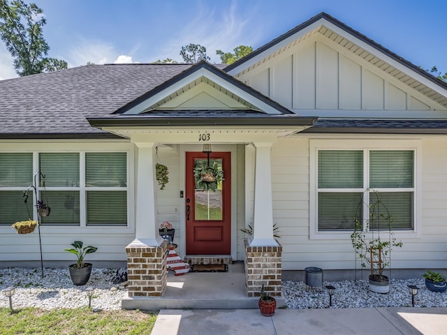 103 Pan Cera Dr, Crawfordville, FL 32327 - property entrance featuring a shingled roof, a porch, and board and batten siding