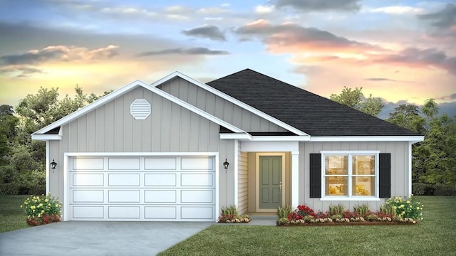 view of front of home featuring a garage and a yard