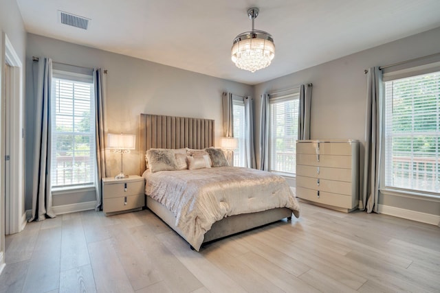 2605 Antietam Trl, Tallahassee, FL 32312 - bedroom featuring a chandelier, baseboards, and light wood-type flooring