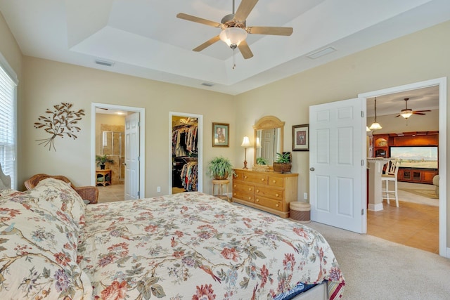 2605 Antietam Trl, Tallahassee, FL 32312 - bedroom featuring a walk in closet, a tray ceiling, light tile patterned flooring, and a closet