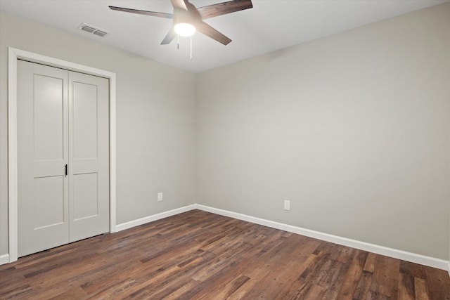 unfurnished bedroom with visible vents, wood finished floors, a closet, baseboards, and ceiling fan