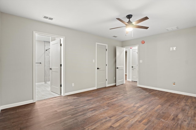 unfurnished bedroom featuring visible vents, baseboards, and wood finished floors