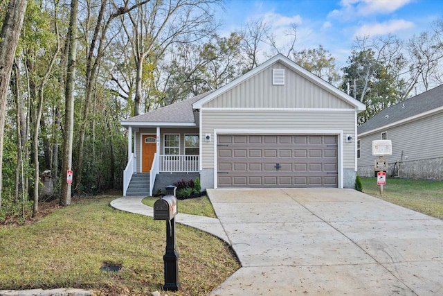 view of front facade featuring board and batten siding, a front yard, roof with shingles, a garage, and driveway