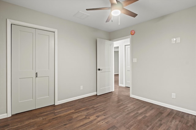 unfurnished bedroom with dark wood finished floors, visible vents, baseboards, and ceiling fan