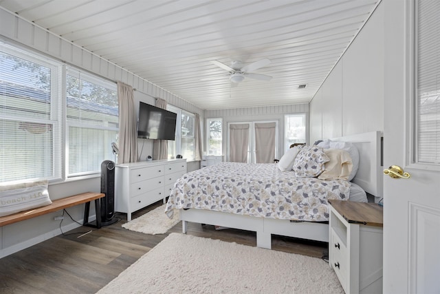 bedroom with multiple windows, ceiling fan, and dark wood-type flooring