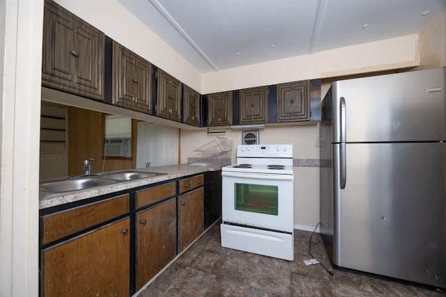 kitchen featuring dark brown cabinetry, stainless steel fridge, sink, and electric range