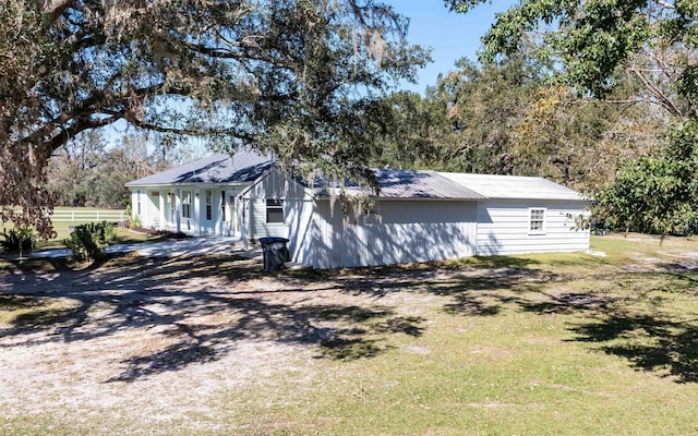 view of side of home featuring a lawn