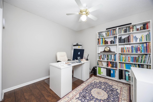 home office featuring ceiling fan, dark wood-type flooring, and a textured ceiling