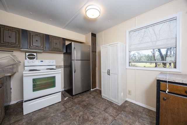 kitchen featuring white range with electric stovetop, stainless steel refrigerator, and dark brown cabinets