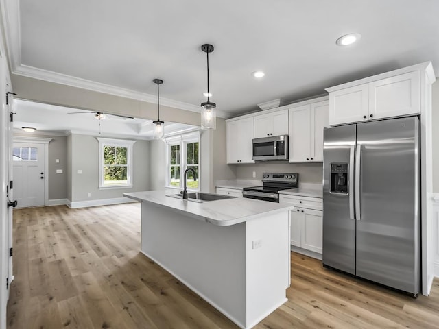 kitchen with a center island with sink, sink, ceiling fan, white cabinetry, and stainless steel appliances