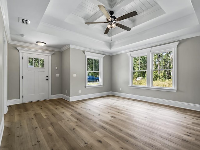 foyer featuring a tray ceiling, hardwood / wood-style flooring, ornamental molding, and ceiling fan