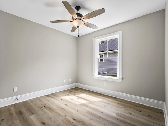 unfurnished room with wood-type flooring, a wealth of natural light, and ceiling fan