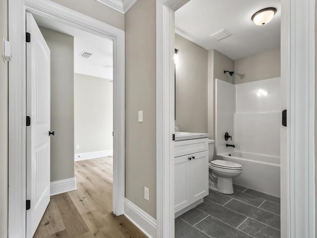 full bathroom featuring bathtub / shower combination, vanity, and toilet