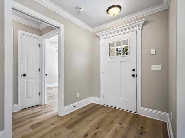 entrance foyer with light wood-type flooring and crown molding