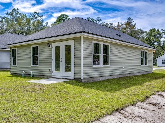 rear view of house with a yard and french doors