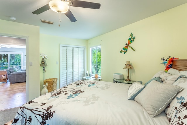627 Mariner Cir, Alligator Point, FL 32346 - bedroom with multiple windows, a closet, ceiling fan, and wood finished floors