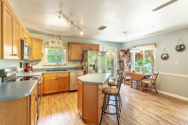 627 Mariner Cir, Alligator Point, FL 32346 - kitchen featuring appliances with stainless steel finishes, a sink, healthy amount of natural light, and light wood-type flooring
