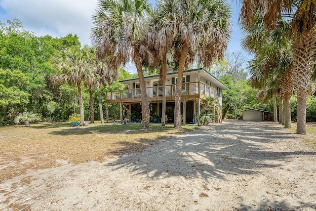 627 Mariner Cir, Alligator Point, FL 32346 - view of front of home with driveway, an outdoor structure, and a deck