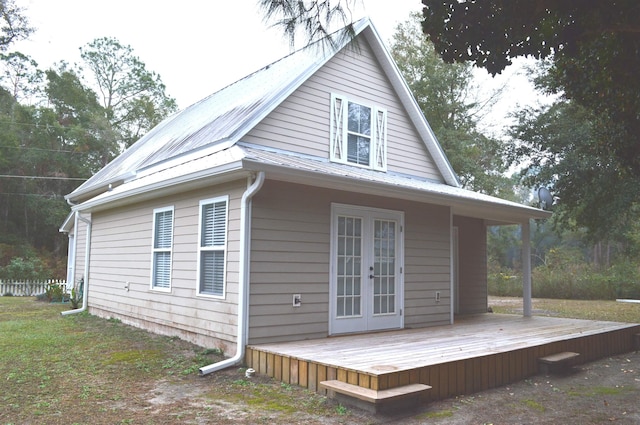 back of house with a wooden deck and french doors