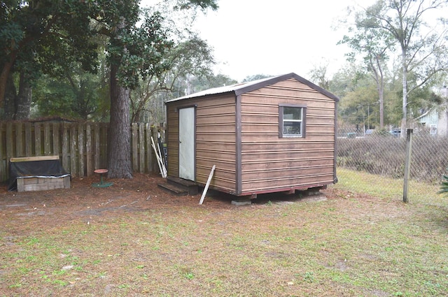 view of outbuilding featuring a yard