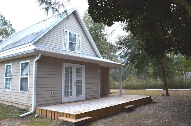 view of property exterior featuring a deck and french doors