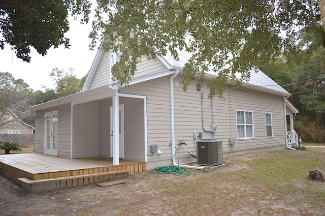 back of property featuring central air condition unit and a wooden deck