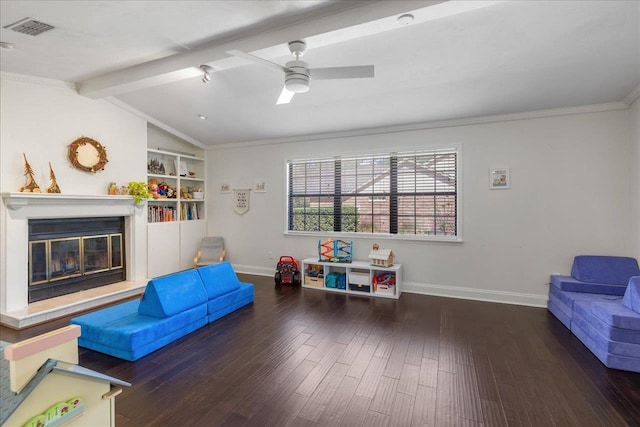 playroom with vaulted ceiling with beams, visible vents, baseboards, dark wood-style floors, and a glass covered fireplace