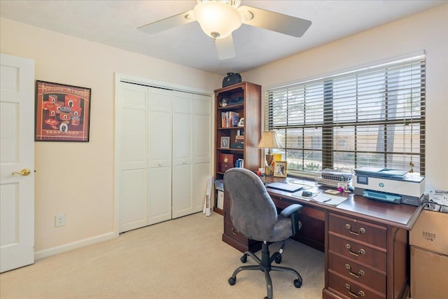 office with light colored carpet, ceiling fan, and baseboards