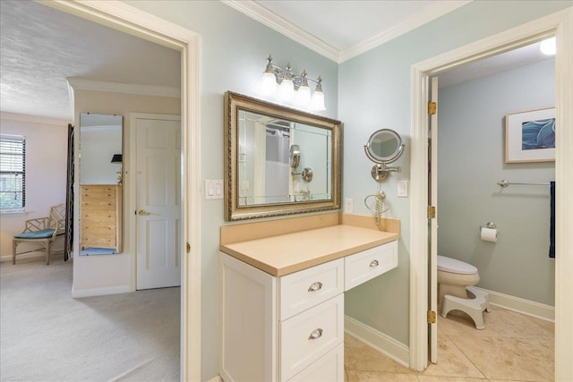 bathroom with ornamental molding, baseboards, vanity, and toilet