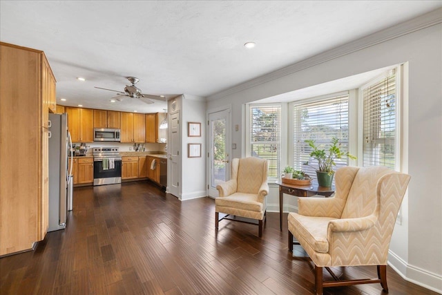 kitchen with stainless steel appliances, dark wood-type flooring, baseboards, light countertops, and crown molding