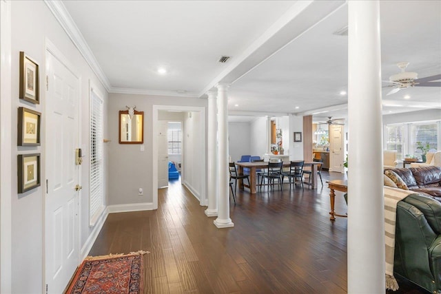 foyer with ceiling fan, visible vents, dark wood-style floors, decorative columns, and crown molding