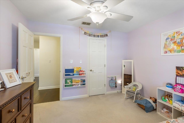 recreation room with a ceiling fan, visible vents, light carpet, and baseboards