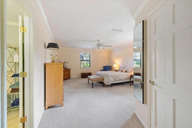 bedroom with light carpet, ceiling fan, ornamental molding, and baseboards