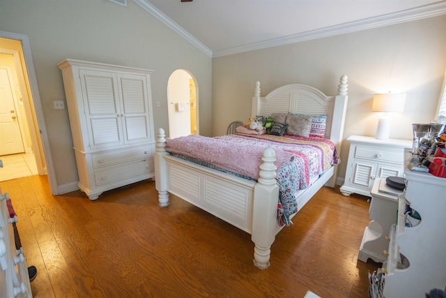 3204 Gallant Fox Trl, Tallahassee, FL 32309 - bedroom featuring wood finished floors, crown molding, vaulted ceiling, arched walkways, and baseboards