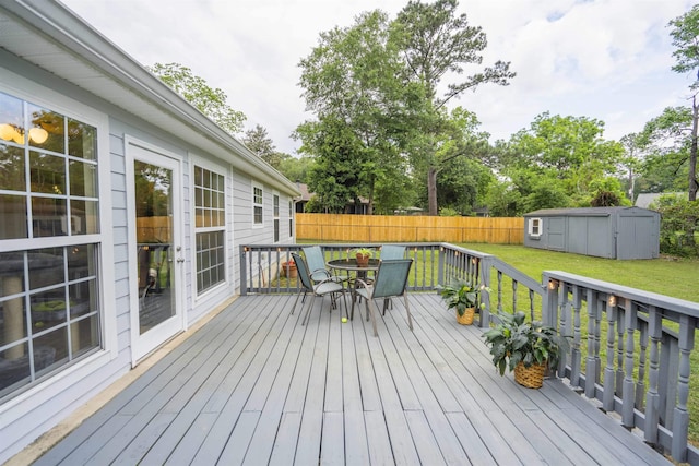 3204 Gallant Fox Trl, Tallahassee, FL 32309 - wooden terrace featuring a storage shed, outdoor dining space, an outdoor structure, and view of wooded area
