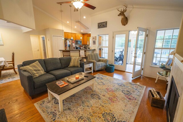 3204 Gallant Fox Trl, Tallahassee, FL 32309 - living room featuring ceiling fan, ornamental molding, light wood finished floors, baseboards, and high vaulted ceiling