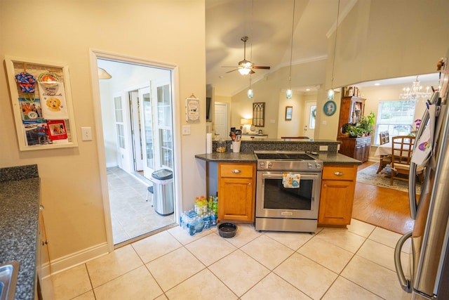 3204 Gallant Fox Trl, Tallahassee, FL 32309 - kitchen with appliances with stainless steel finishes, brown cabinets, a ceiling fan, a peninsula, and vaulted ceiling
