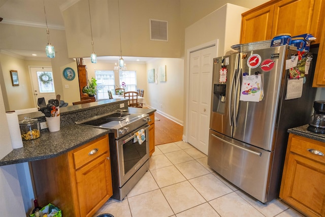 3204 Gallant Fox Trl, Tallahassee, FL 32309 - kitchen with appliances with stainless steel finishes, crown molding, brown cabinetry, light tile patterned flooring, and decorative light fixtures