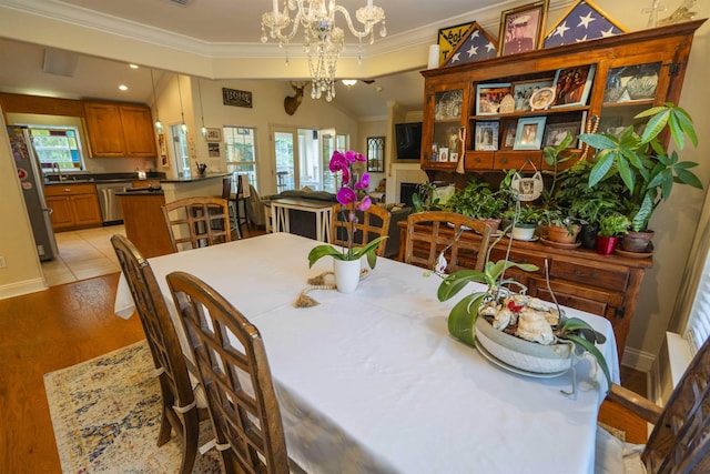 3204 Gallant Fox Trl, Tallahassee, FL 32309 - dining space featuring ornamental molding, a chandelier, light wood-type flooring, and baseboards