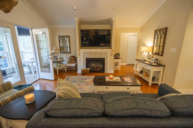 3204 Gallant Fox Trl, Tallahassee, FL 32309 - living room featuring ornamental molding, wood finished floors, baseboards, and a tiled fireplace