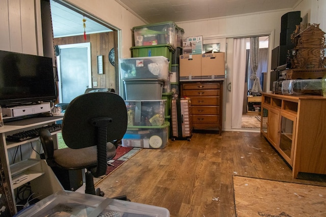 office with crown molding, wood walls, and hardwood / wood-style flooring