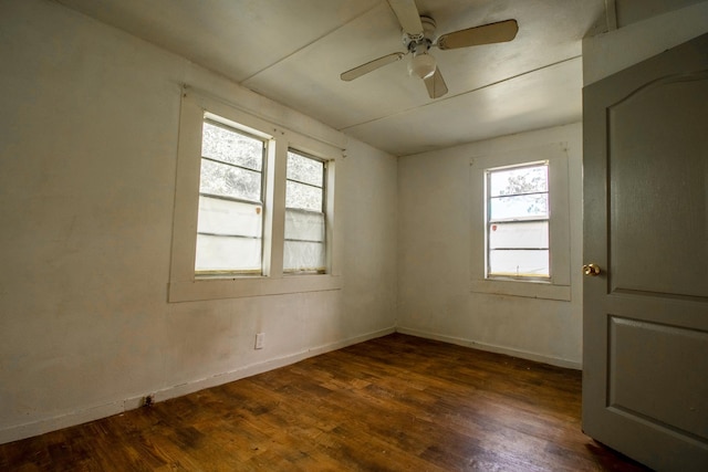 empty room featuring ceiling fan and dark hardwood / wood-style flooring