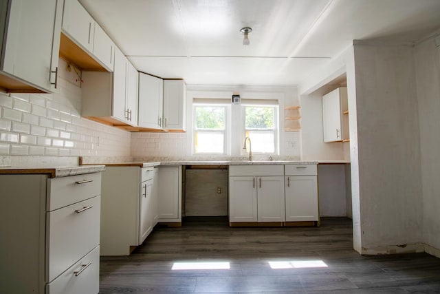 kitchen featuring white cabinetry, dark hardwood / wood-style flooring, stainless steel dishwasher, and sink