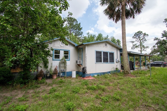 back of property featuring a yard