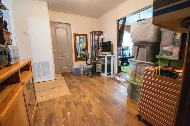 interior space featuring wood-type flooring and ornamental molding