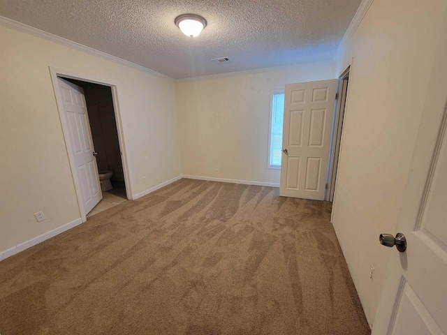 carpeted empty room featuring a textured ceiling and ornamental molding