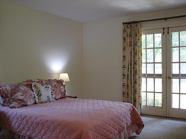 3705 Foxford Cir, Tallahassee, FL 32309 - carpeted bedroom with french doors