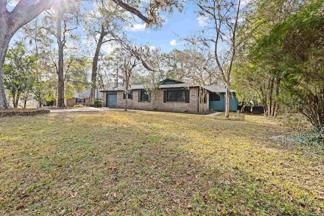 ranch-style house with a garage and a front lawn