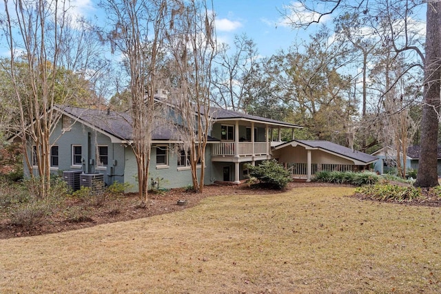 back of property with cooling unit and a lawn