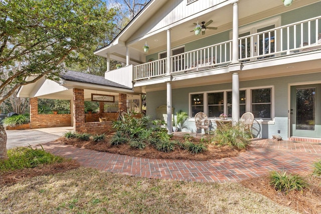 exterior space featuring ceiling fan and a balcony